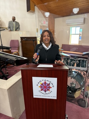 Regina Ross seated with Detroit residents