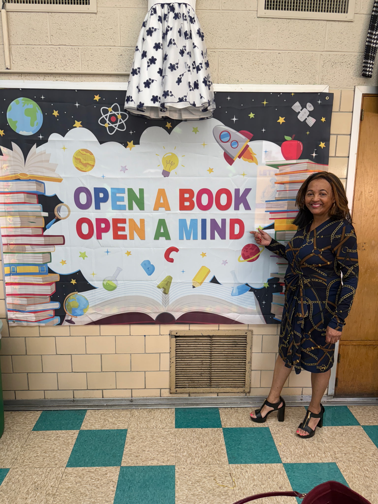 Regina Ross beside an open a book display