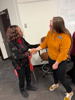 Regina Ross shaking hands with a supporter